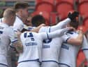 Max Power is mobbed after opening the scoring for Latics