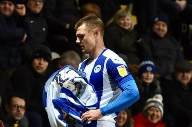 Max Power enjoys a joke with the away fans by bringing out the towel