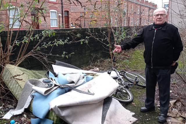 Coun George Davies with the dumped items