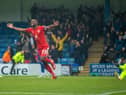 Tendayi Darikwa celebrates Latics' 2-0 victory at Gillingham back in October