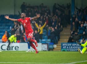 Tendayi Darikwa celebrates Latics' 2-0 victory at Gillingham back in October