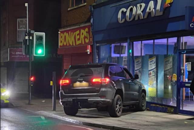 The stolen car smashed into a betting shop window - next door to a shop called Bonkers (Photo Lancs Police Tac Ops).