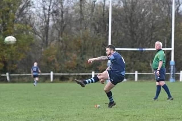 Rhodri Carlton Jones kicks for goal