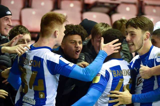 The youthful Latics side celebrate their victory over Arsenal Under-21s in midweek