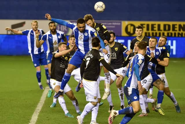 Josh Magennis heads for goal