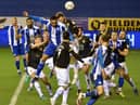 Josh Magennis heads for goal