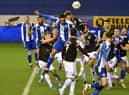 Josh Magennis heads for goal