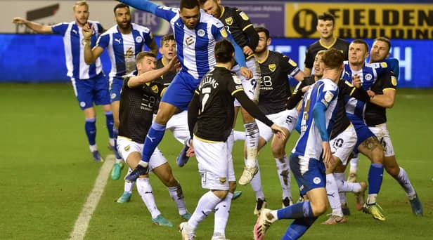 Josh Magennis heads for goal