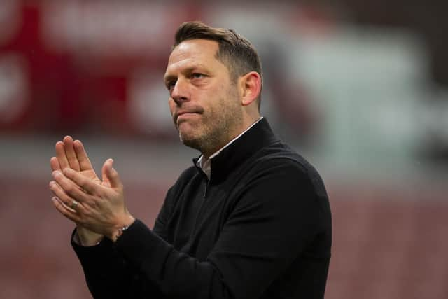 Leam Richardson applauds the travelling Latics fans at Stoke