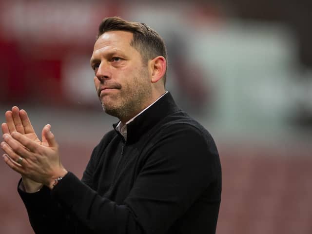 Leam Richardson applauds the travelling Latics fans at Stoke