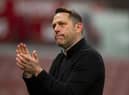 Leam Richardson applauds the travelling Latics fans at Stoke