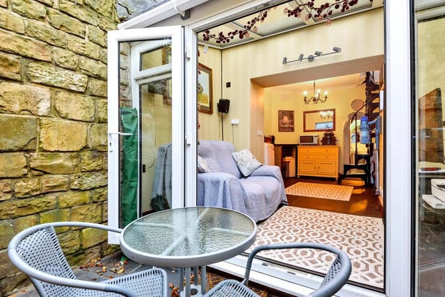 French doors then lead to the sunken garden with stunning wall feature, shrubs and seating area.