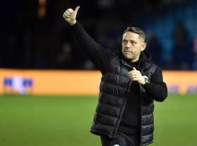 Leam Richardson salutes the travelling Latics fans at Sheffield Wednesday in midweek