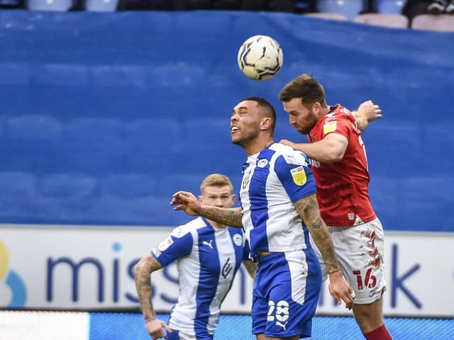 Josh Magennis competes for the ball against Charlton
