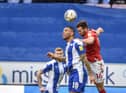 Josh Magennis competes for the ball against Charlton