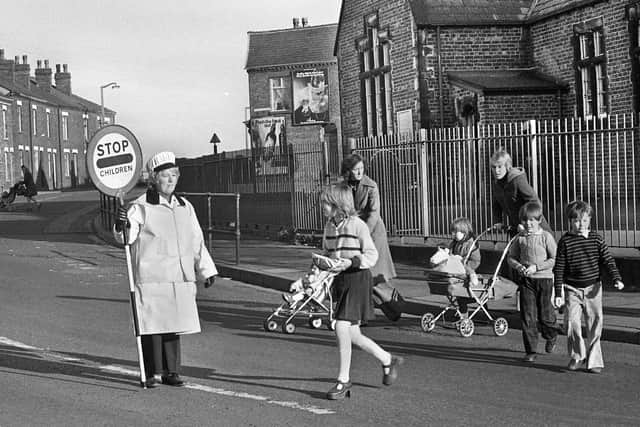 Liverpool Road, Platt Bridge, in 1976 and lollipop lady Mrs. Hargreaves shepherds kids and mums across from the old St. Nathaniel's Primary School.