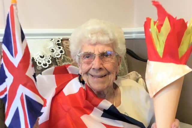 Doreen Wilkinson with her homemade olympic torches