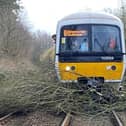 Workers clearing branches of a tree from the tracks after Storm Eunice