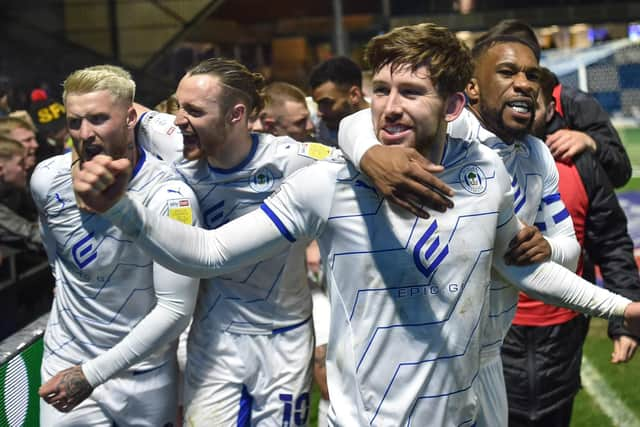 Callum Lang is congratulated by Will Keane, Stephen Humphrys and Tendayi Darikwa at Wycombe