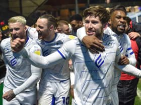 Callum Lang is congratulated by Will Keane, Stephen Humphrys and Tendayi Darikwa at Wycombe