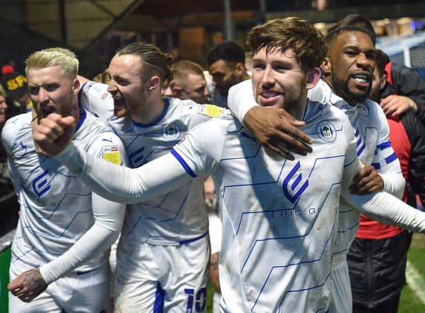Callum Lang is congratulated by Will Keane, Stephen Humphrys and Tendayi Darikwa at Wycombe