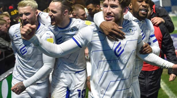 Callum Lang is congratulated by Will Keane, Stephen Humphrys and Tendayi Darikwa at Wycombe