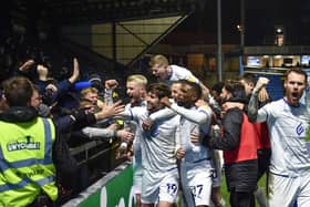 The Latics side celebrate in front of the away end at Wycombe