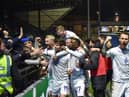 The Latics side celebrate in front of the away end at Wycombe