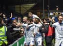 The Latics side celebrate in front of the away end at Wycombe