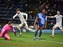 Callum Lang wheels away in delight after scoring his second and Latics' third goal