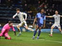 Callum Lang wheels away in delight after scoring his second and Latics' third goal