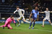 Callum Lang wheels away in delight after scoring his second and Latics' third goal