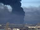Black smoke rises from a military airport in Chuguyev near Kharkiv on February 24, 2022. - Russian President Vladimir Putin announced a military operation in Ukraine today with explosions heard soon after across the country and its foreign minister warning a "full-scale invasion" was underway.
