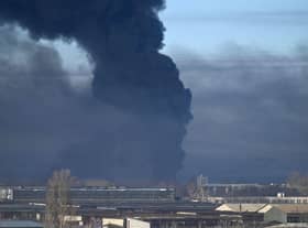 Black smoke rises from a military airport in Chuguyev near Kharkiv on February 24, 2022. - Russian President Vladimir Putin announced a military operation in Ukraine today with explosions heard soon after across the country and its foreign minister warning a "full-scale invasion" was underway.