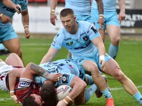 Wigan's Ollie Partington crosses for a try against Wakefield