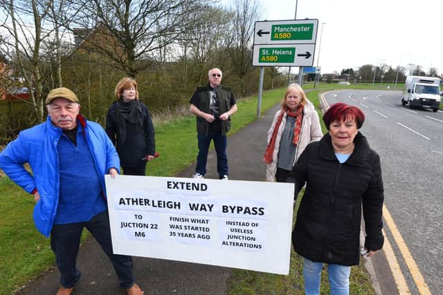 Campaigners holding a placard calling for the bypass to be extended