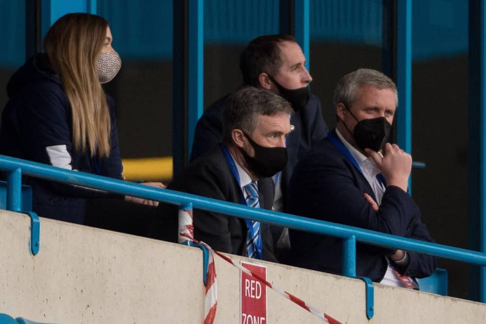 Mal Brannigan (second left) watches the recent match at Gillingham