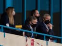 Mal Brannigan (second left) watches the recent match at Gillingham