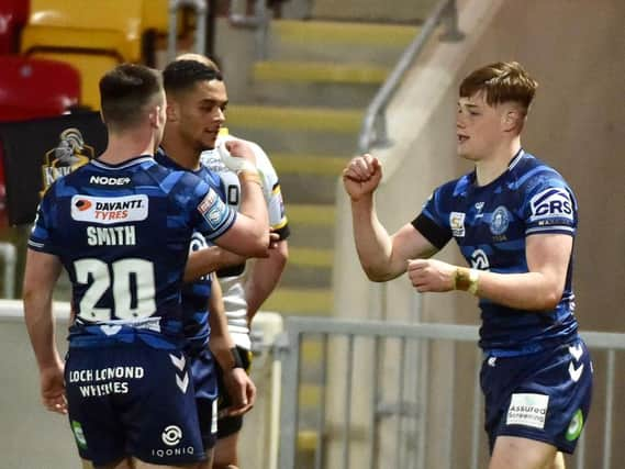 Sam Halsall celebrates his try with Harry Smith and Umyla Hanley