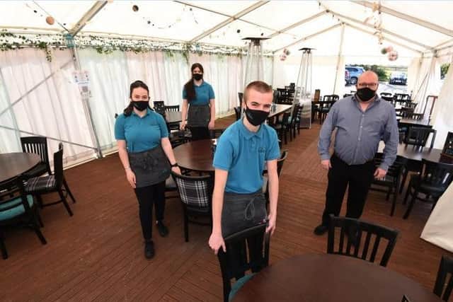 Staff, from left, Ciara Tordoff, Zara McKenna, Charlie Anderson and Mathew Willis, are ready to welcome customers to their marquee beer garden at The Crown, Worthington