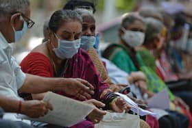 People wait for their turn to receive the Covid-19 coronavirus vaccine at a government hospital in Chennai  (Photo by ARUN SANKAR/AFP via Getty Images)