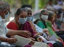 People wait for their turn to receive the Covid-19 coronavirus vaccine at a government hospital in Chennai  (Photo by ARUN SANKAR/AFP via Getty Images)