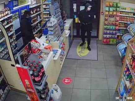 Police want to identify this man after a shop robbery in Wigan