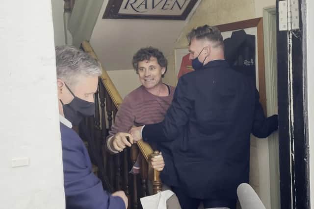 Screengrab taken from PA video of Rod Humphris (centre) landlord of the Raven pub grapples with a member of Keir Starmer's team after refusing entry to the Labour leader