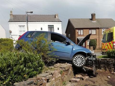 The car in the bushes after the crash outside The Stag Garswood, Station Road