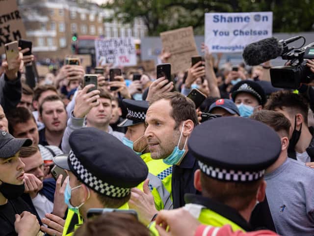 Chelsea Technical Advisor Petr Čech (centre) speaks to fans of Chelsea Football Club protesting outside the team's Stamford Bridge ground on April 20, 2021 in London, England.