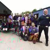 George Melling, in the rickshaw, with staff at Global Engineering who are preparing to travel 36 miles to Blackpool