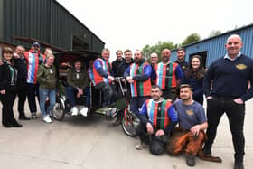 George Melling, in the rickshaw, with staff at Global Engineering who are preparing to travel 36 miles to Blackpool