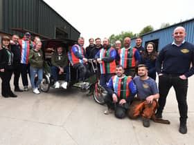 George Melling, in the rickshaw, with staff at Global Engineering who are preparing to travel 36 miles to Blackpool