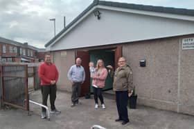 Coun Steve Jones (first left) with volunteers outside the new community centre